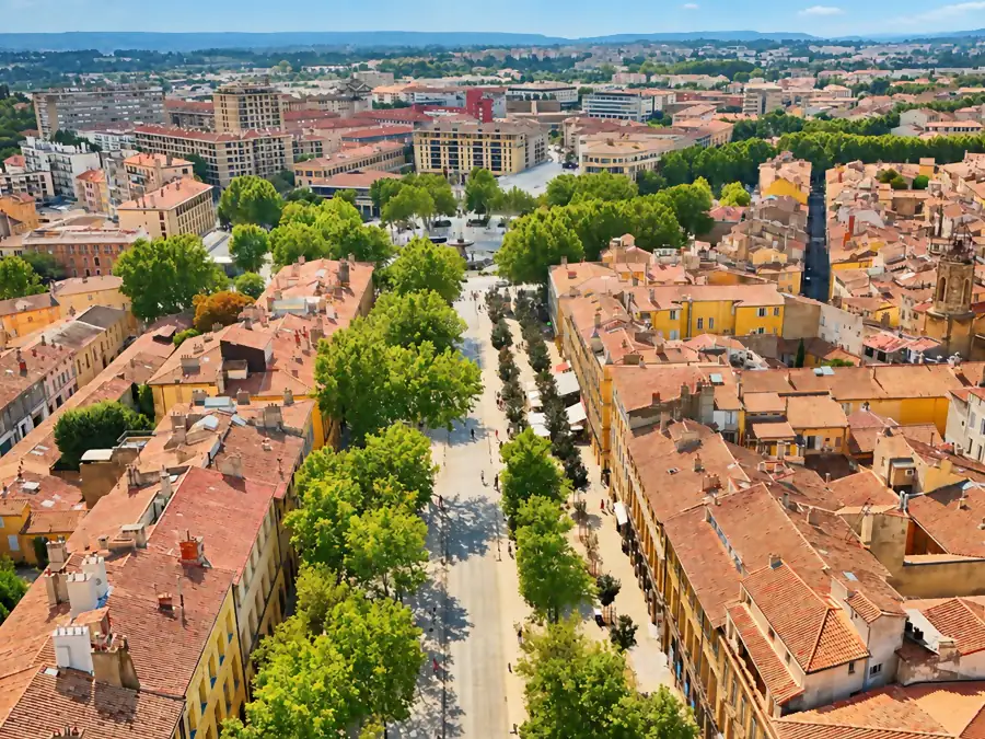 The Cours Mirabeau and its plane trees seen from above, between ocher facades and the rooftops of Aix-en-Provence