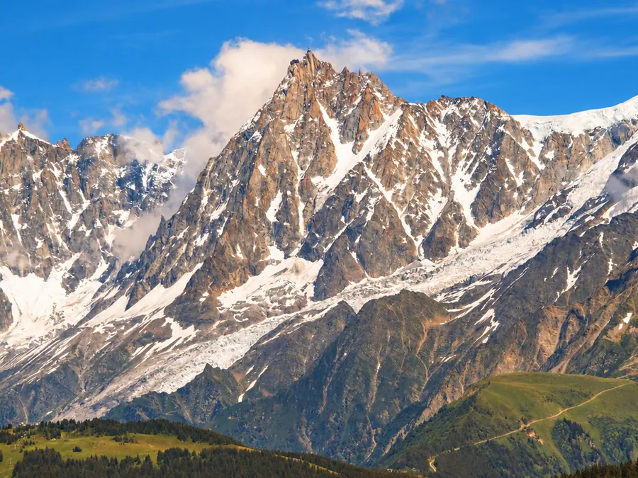 High snowy peaks and their glaciers above the alpine pastures
