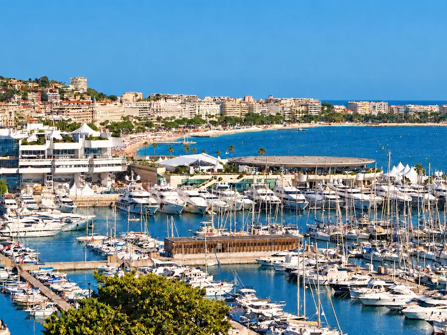 View over the marinas and the Palais des Festivals in Cannes, with the Croisette following the bay behind