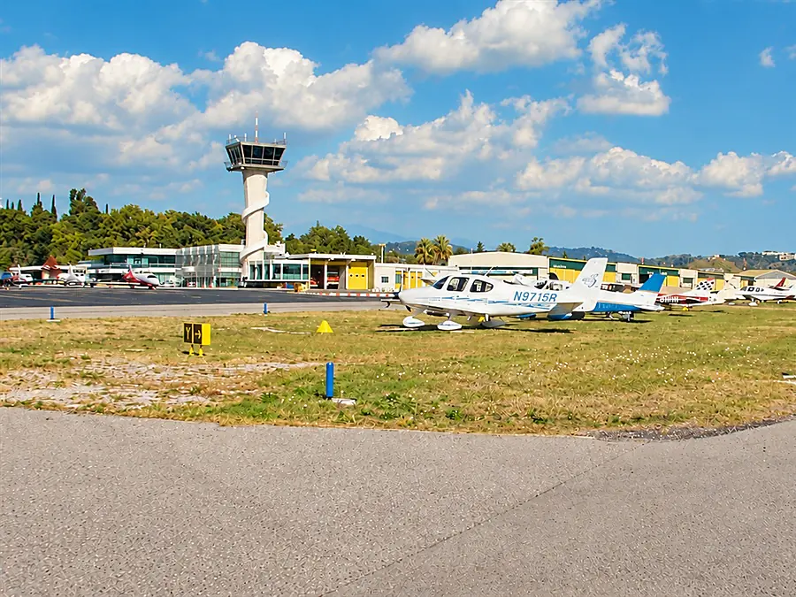 La piste et la tour de contrôle de l’aéroport de Cannes-Mandelieu, avec des avions légers sur l’aire de stationnement