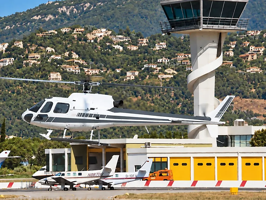 Un hélicoptère stationné près de la tour de contrôle et du FBO de l’aéroport de Cannes-Mandelieu