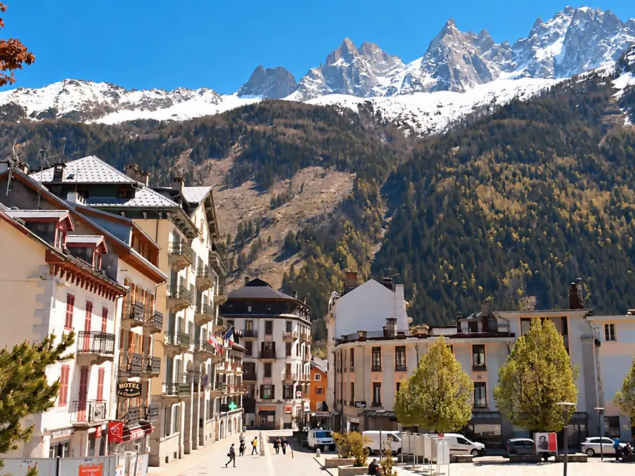 Downtown Chamonix, its hotels and square, below the snowy needles of the Mont Blanc massif