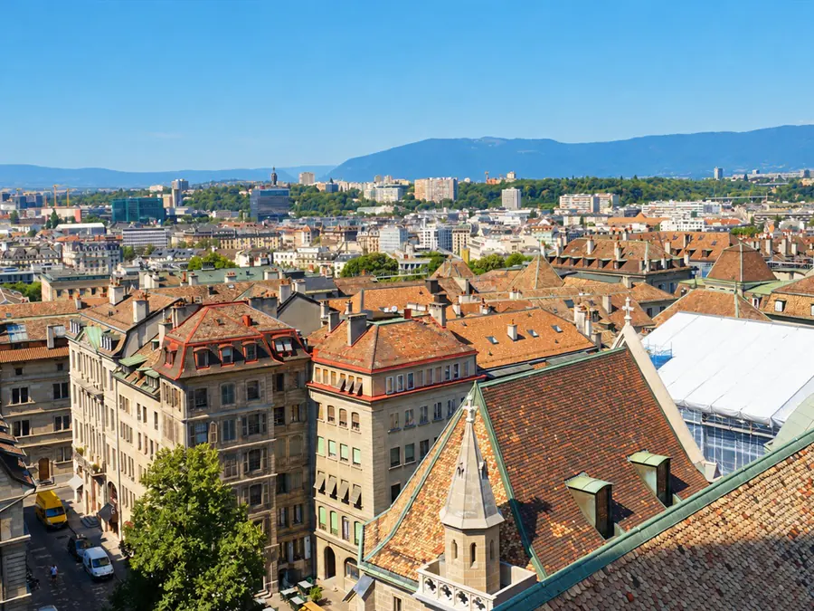 The rooftops of Geneva’s Old Town, with mountains on the horizon