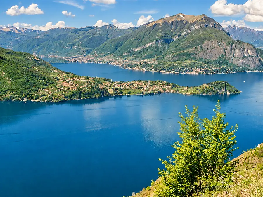 Lake Como seen from above, its mountains and a small peninsula lined with villages