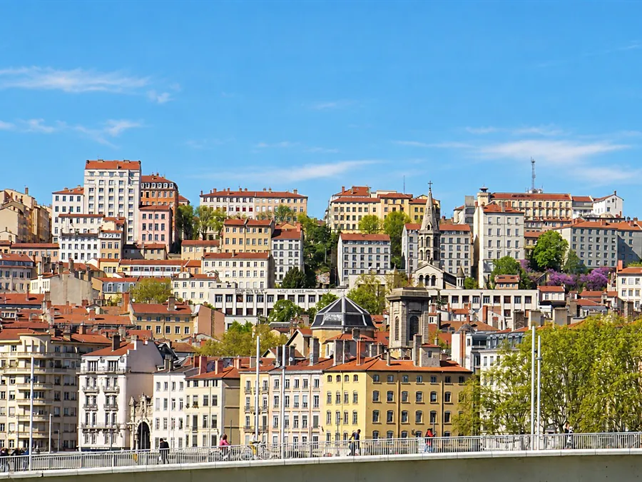 Lyon’s facades rising up the hillside, seen from a footbridge