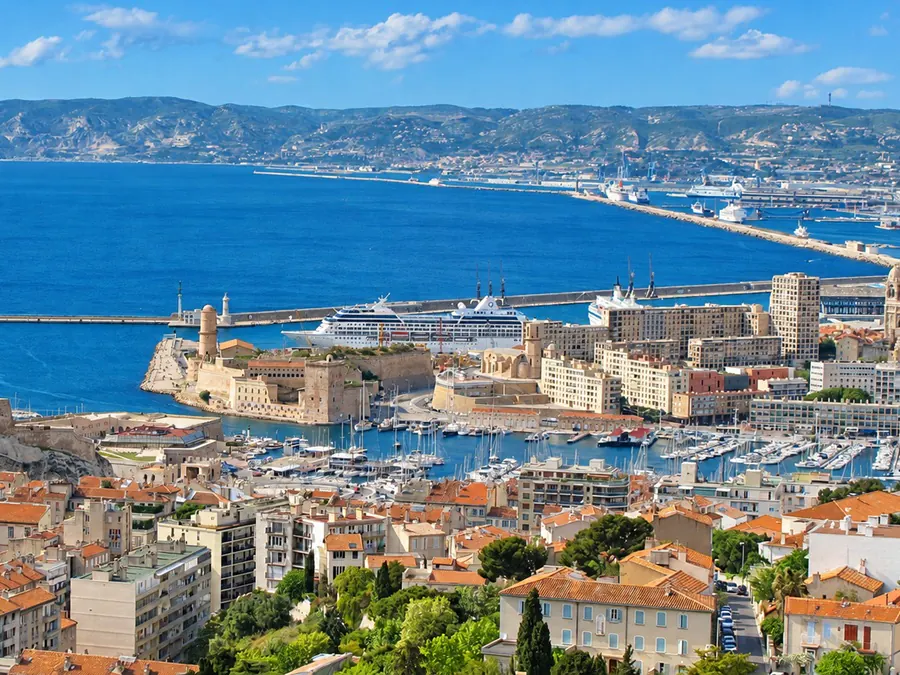 Marseille’s Old Port and Fort Saint-Jean seen from Notre-Dame de la Garde, a cruise ship at the quay and the bay beyond