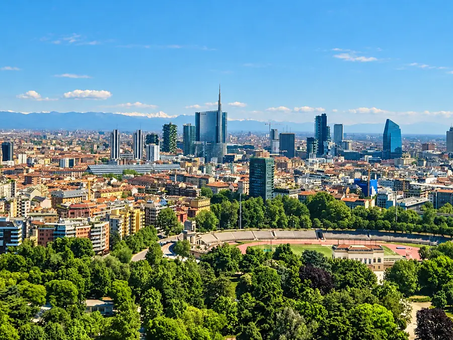 Milan seen from above Parco Sempione, the Porta Nuova towers and the snowcapped Alps on the horizon