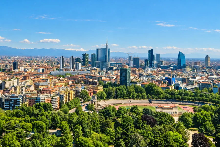 Milan seen from above Parco Sempione, the Porta Nuova towers and the snowcapped Alps on the horizon