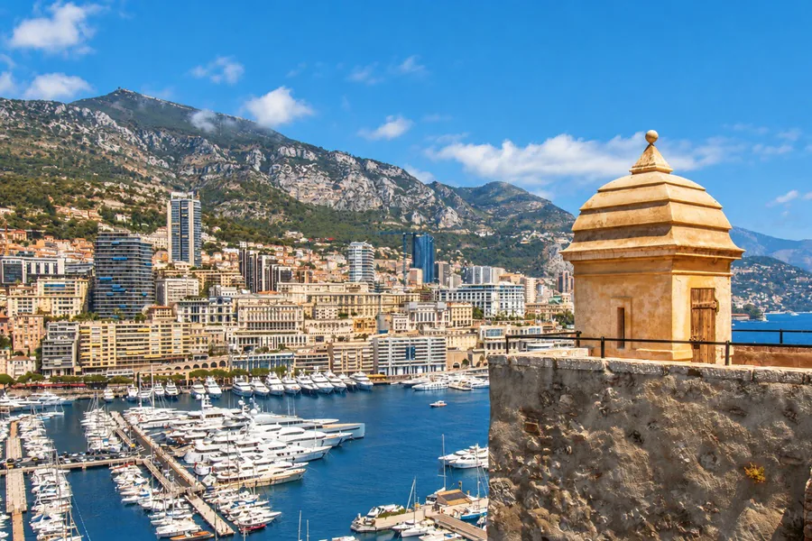 Port Hercules and the buildings of Monte Carlo seen from the ramparts of the Rock, a stone sentry box in the foreground