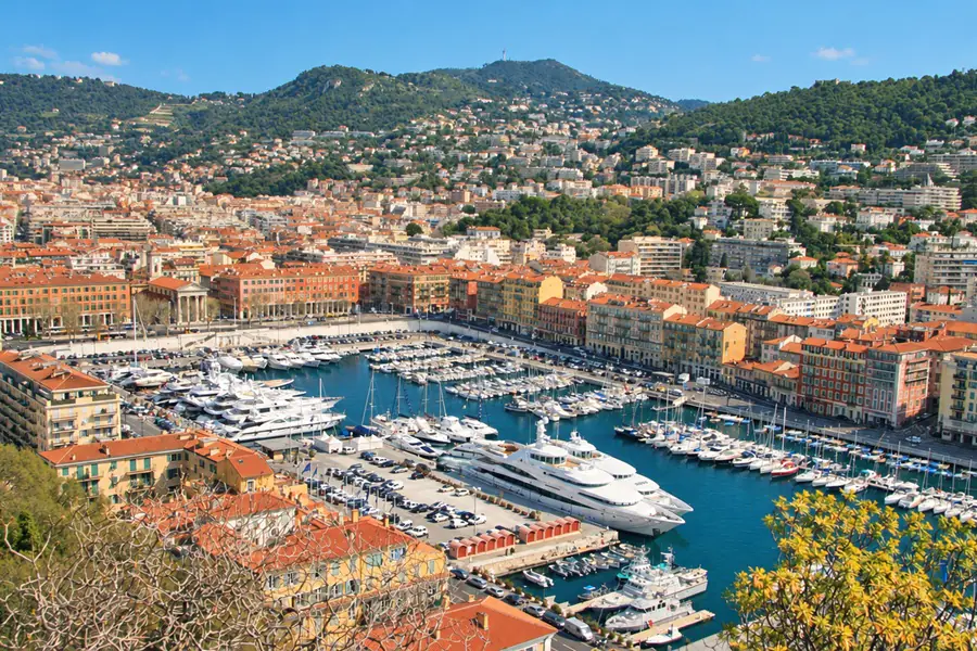 The port of Nice seen from the heights, its yachts and the ochre facades around the harbor, below the hills