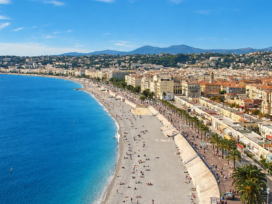The Promenade des Anglais and the pebble beach along the Baie des Anges in Nice