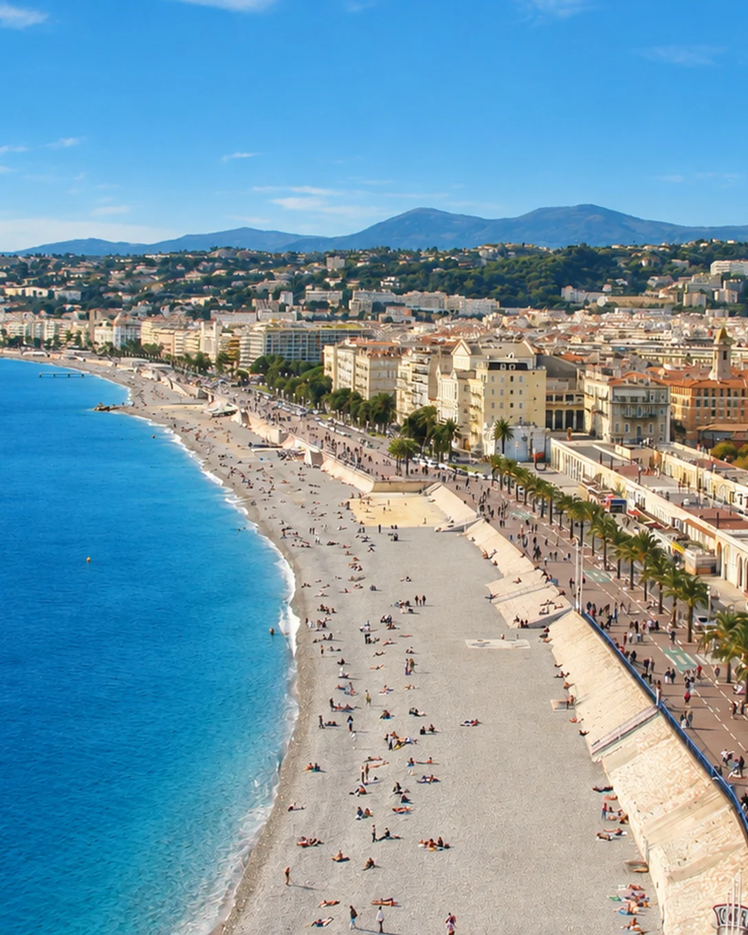 The Promenade des Anglais and the pebble beach along the Baie des Anges in Nice