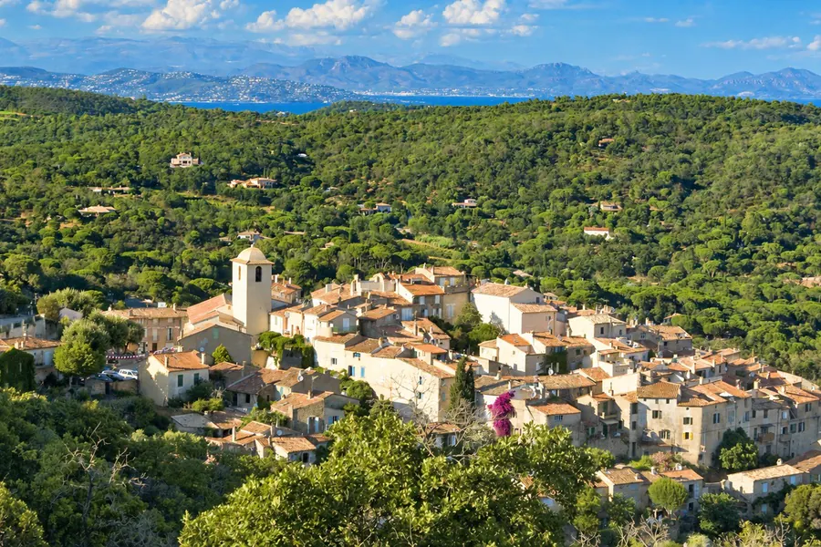 The village of Ramatuelle, its stone houses and bell tower, among the pines and the hills